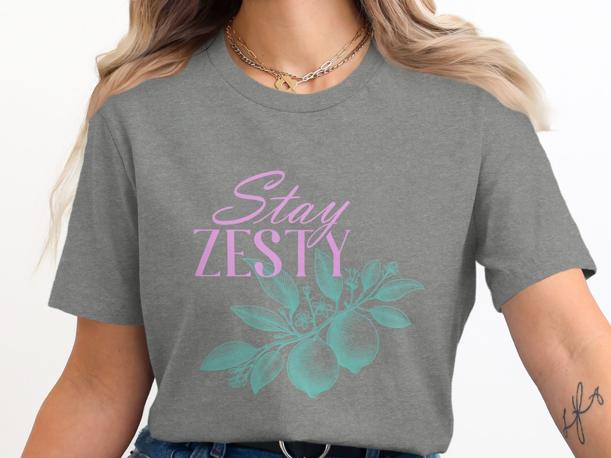 Grey t-shirt with "Stay Zesty" text and lemon branch graphic.