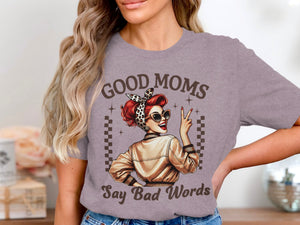 Woman in t-shirt with "Good Moms Say Bad Words" graphic and retro woman illustration.