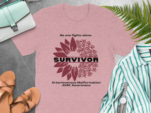 Pink t-shirt with "SURVIVOR", AVM awareness ribbon design, and text.