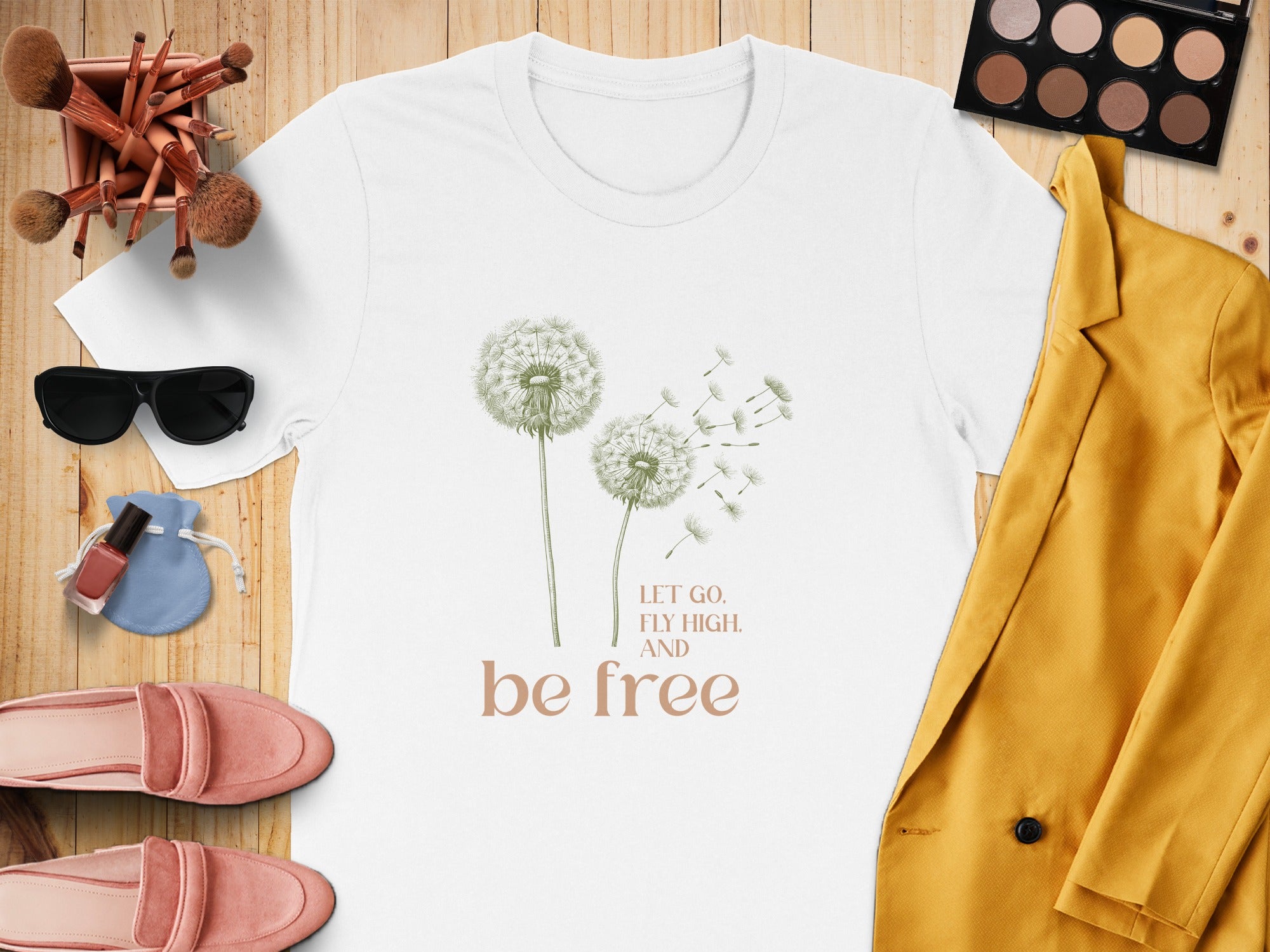 White t-shirt with dandelions and "Let Go. Fly High. And Be Free." text.