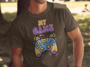 Brown t-shirt with yellow and purple text "MY GAME" and a cat-themed video game controller.