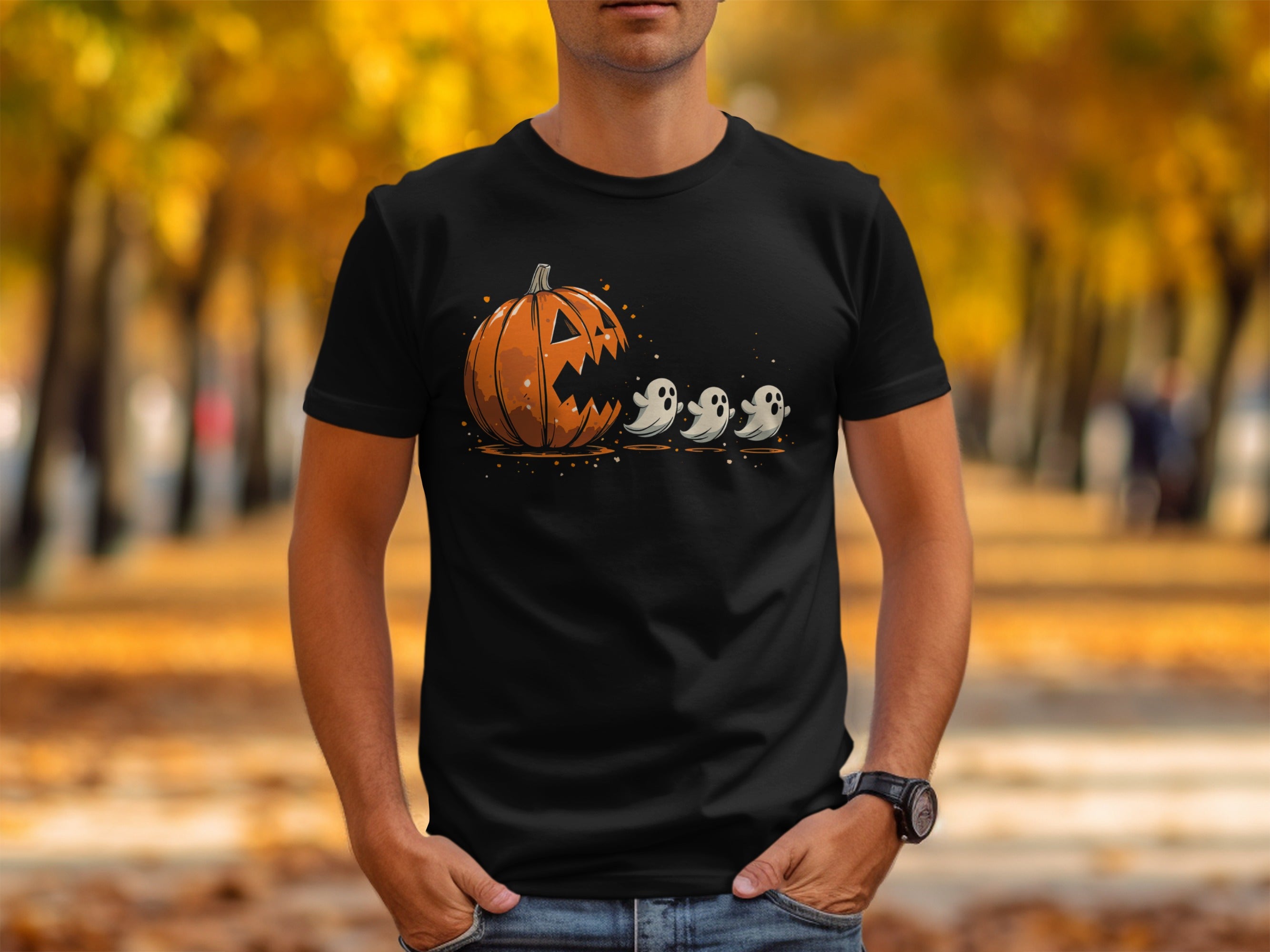 Black t-shirt with a carved pumpkin and three ghosts graphic.