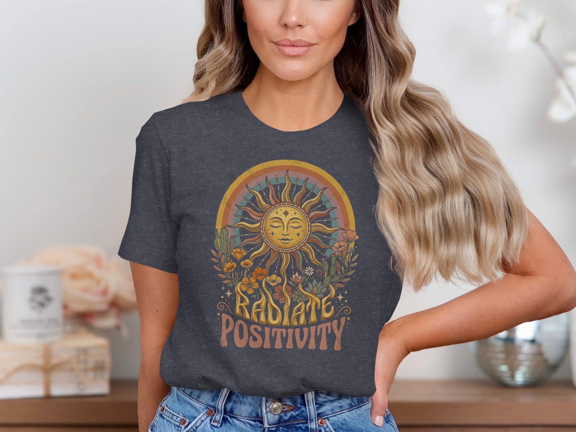 Radiate positivity graphic on a dark grey t-shirt with sun, rainbow, flowers, and cacti.
