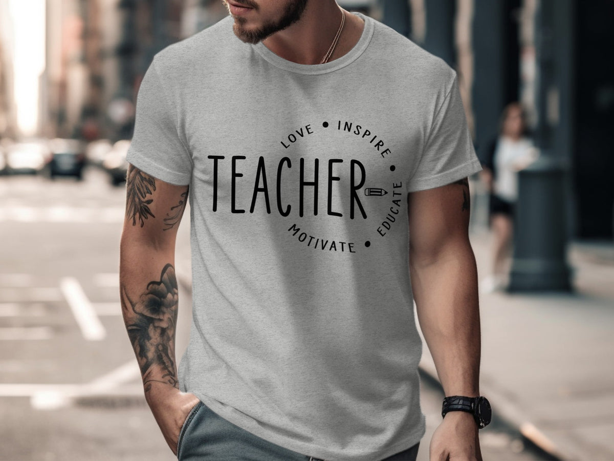 Grey t-shirt with black text "TEACHER" and circular design elements.