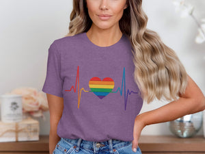 Purple t-shirt with a rainbow heart and heartbeat graphic.