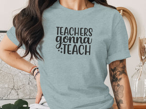 Light blue t-shirt with "Teachers gonna Teach" text in black.