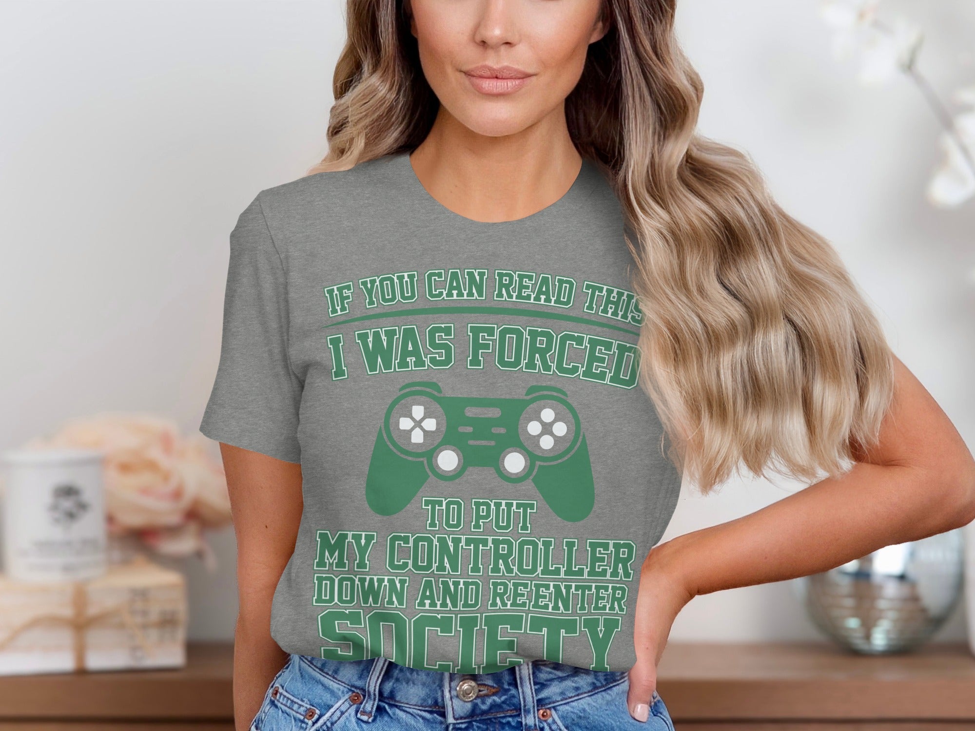Grey t-shirt with text and video game controller graphic.