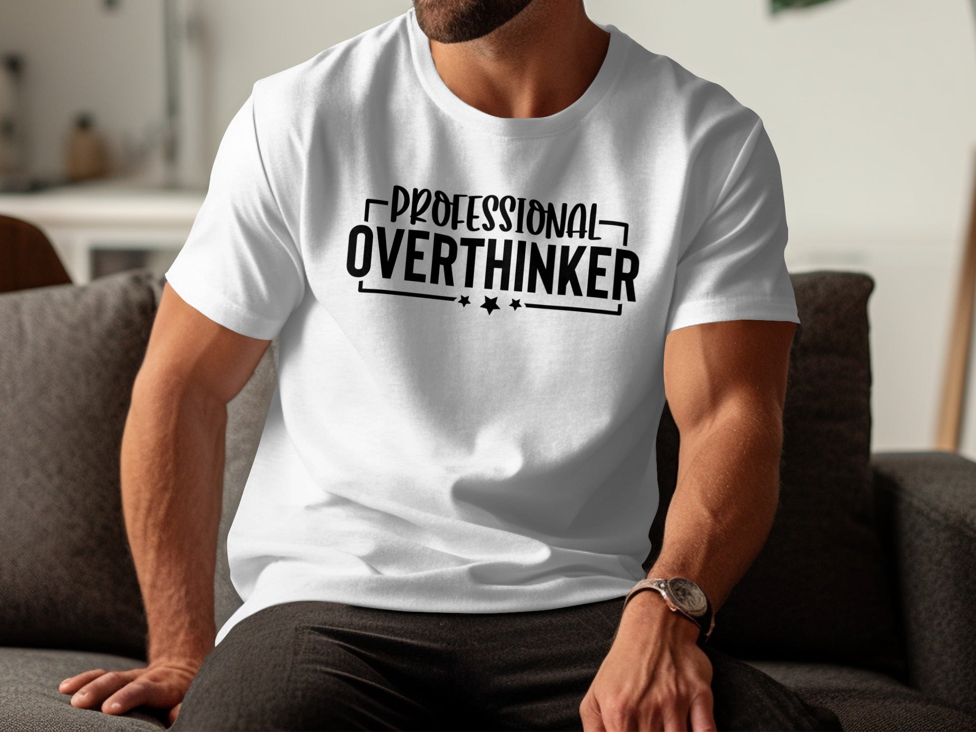 White t-shirt with black text reading "PROFESSIONAL OVERTHINKER" and stars.