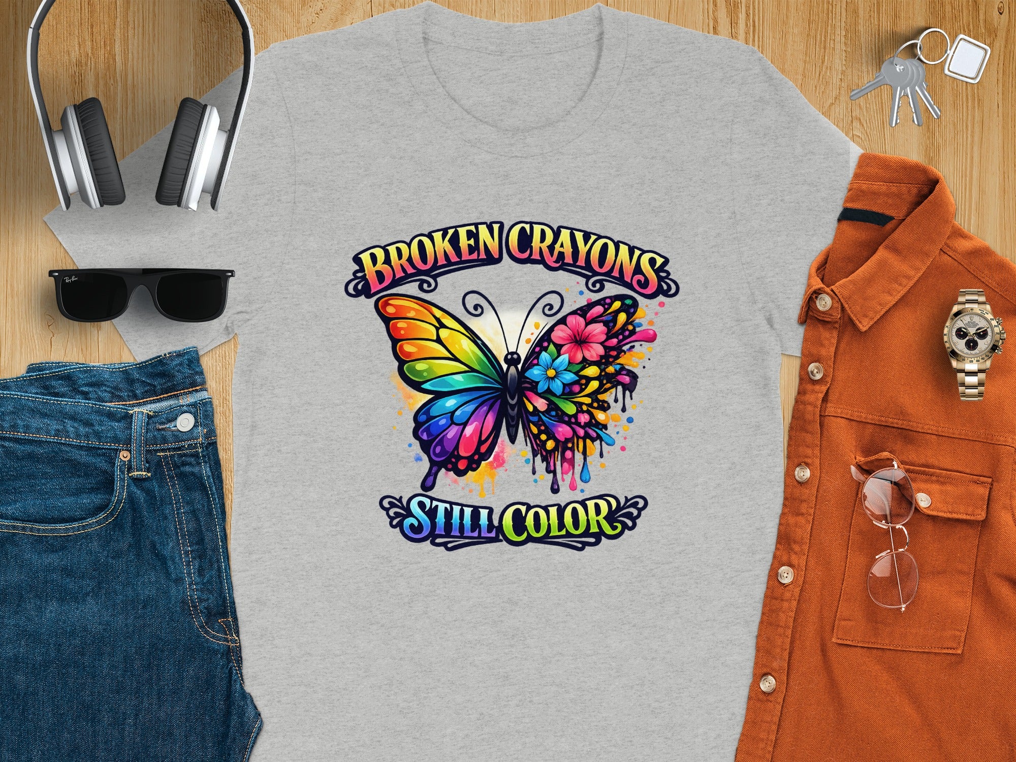 Gray t-shirt with butterfly graphic and text "BROKEN CRAYONS STILL COLOR"