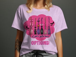 Pink t-shirt with Halloween brooms, bats, ghosts, and pumpkins. Text reads "A girl's gotta have OPTIONS!".