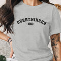 Grey t-shirt with "OVERTHINKER 24/7" text on the front.