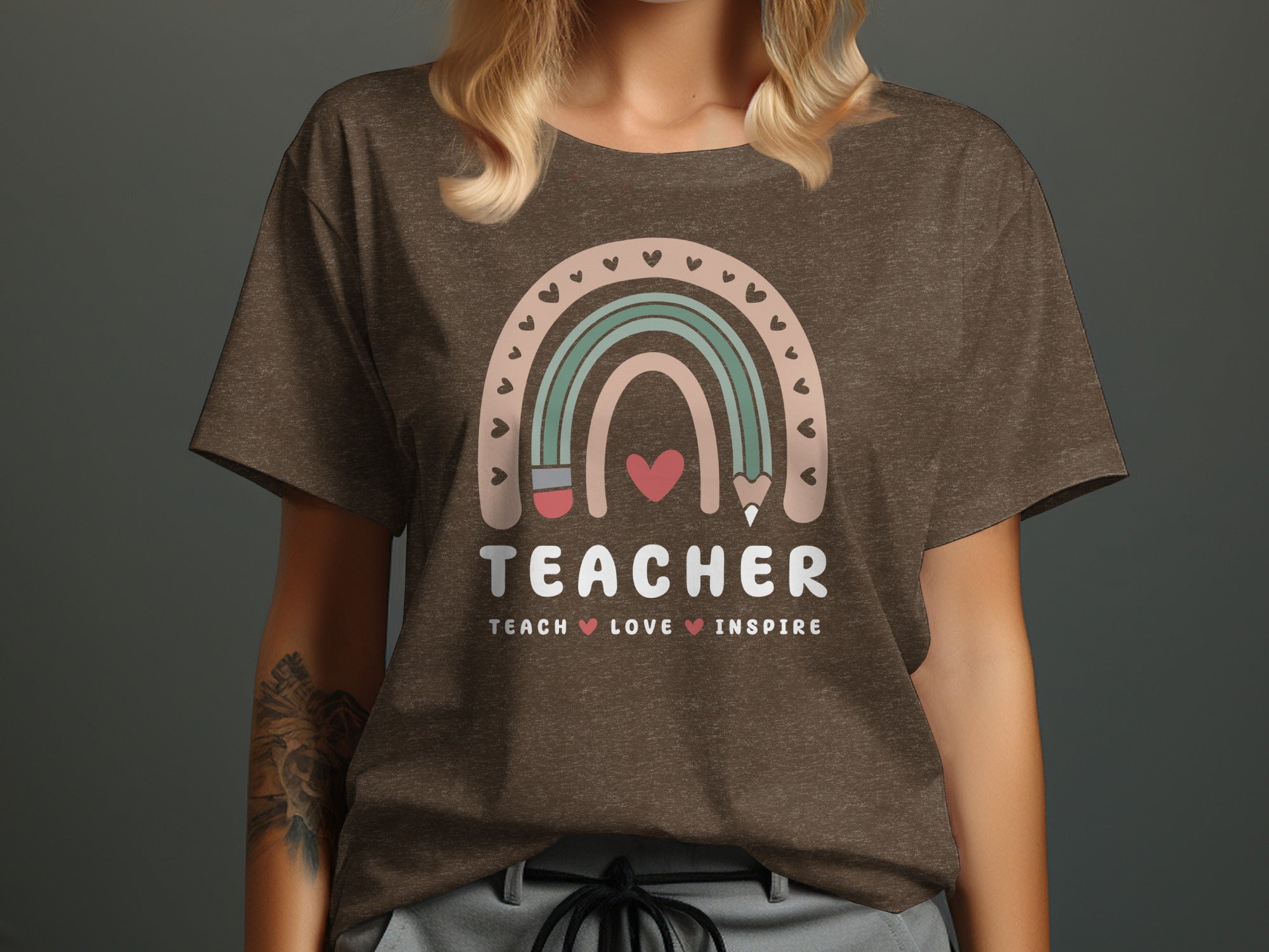Brown t-shirt with rainbow graphic and the words "TEACHER TEACH LOVE INSPIRE".