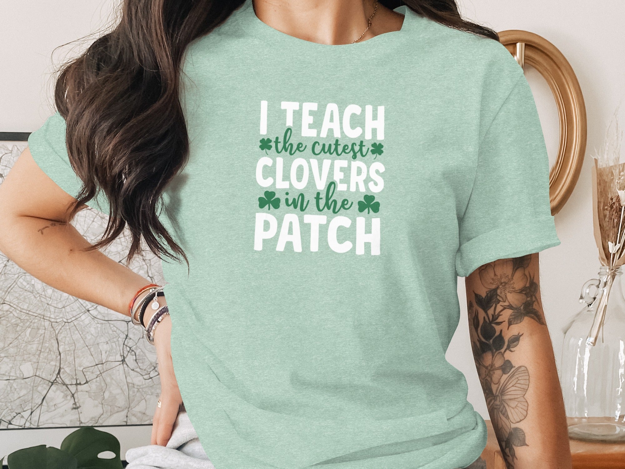 Mint t-shirt with white text reading "I TEACH the cutest CLOVERS in the PATCH".