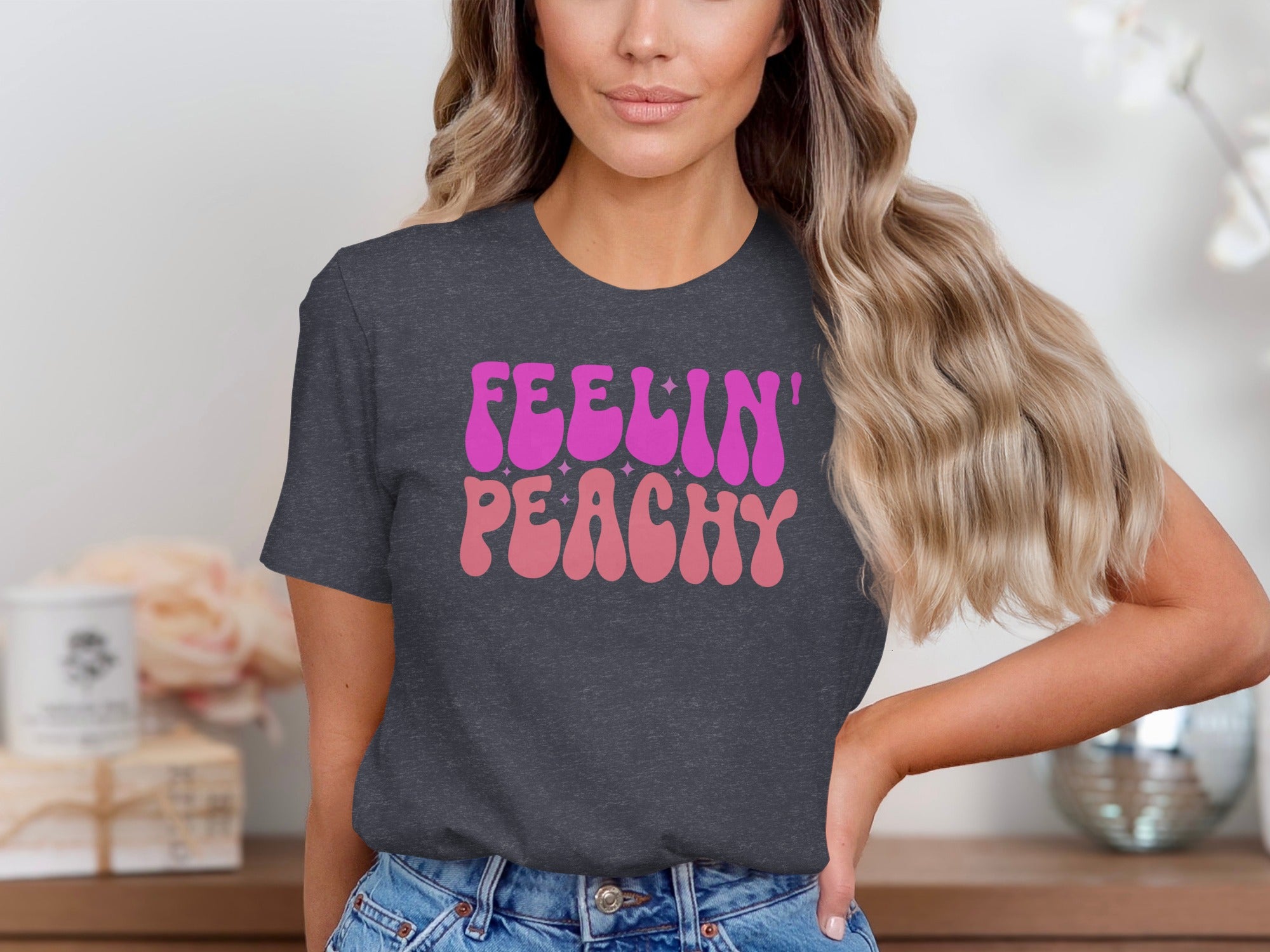 Dark gray t-shirt with pink and light pink "Feelin' Peachy" text.