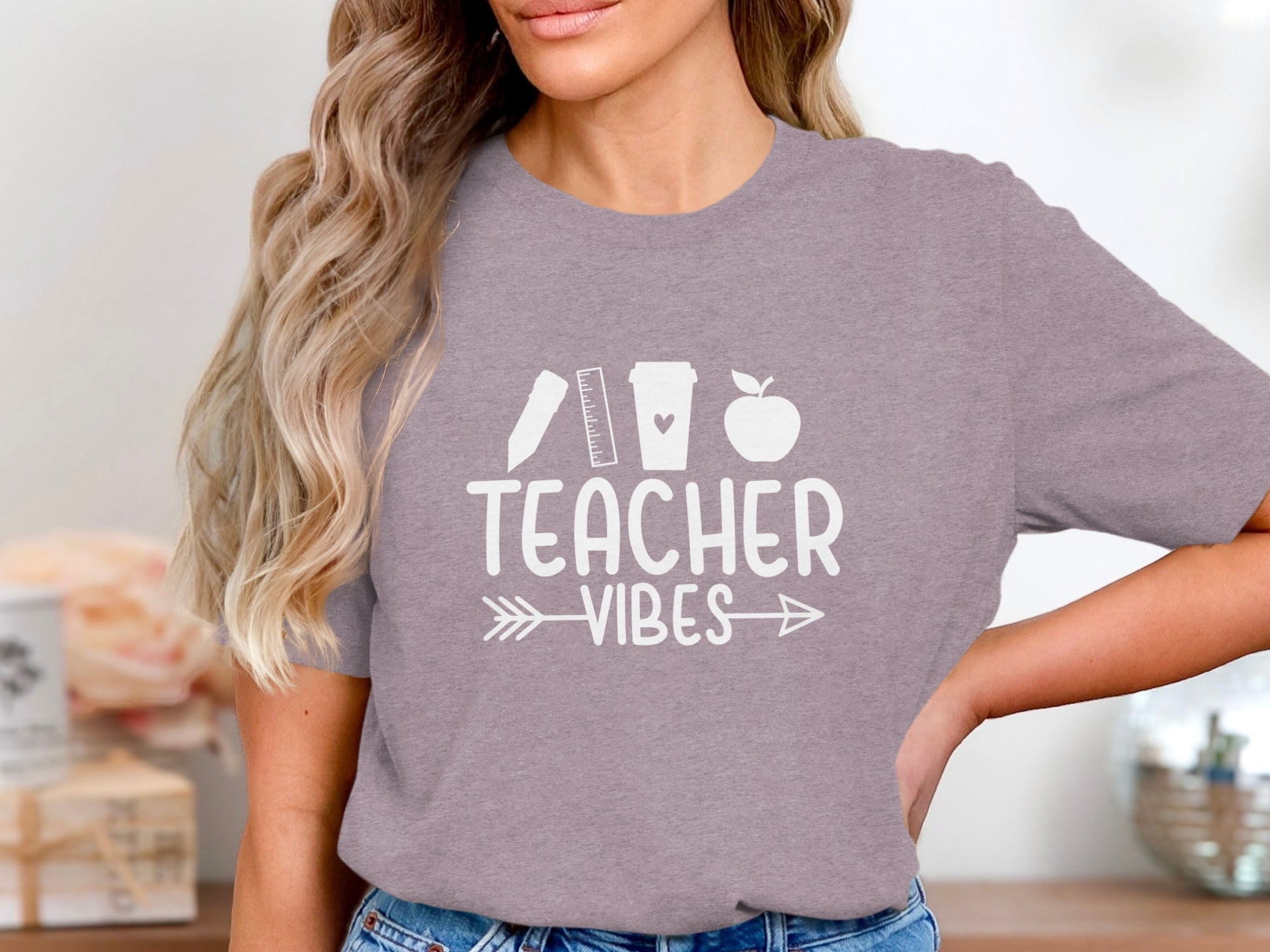 Gray t-shirt with white text "TEACHER VIBES" and school icons.