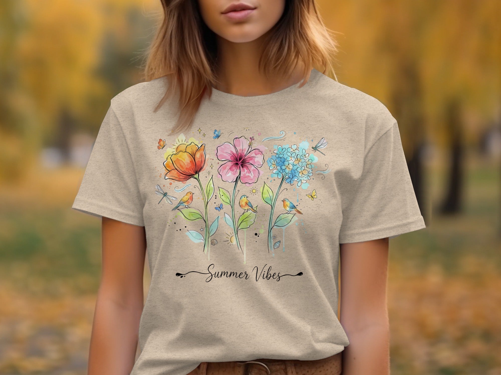 Tan t-shirt featuring watercolor flowers, birds, butterflies, and "Summer Vibes" text.