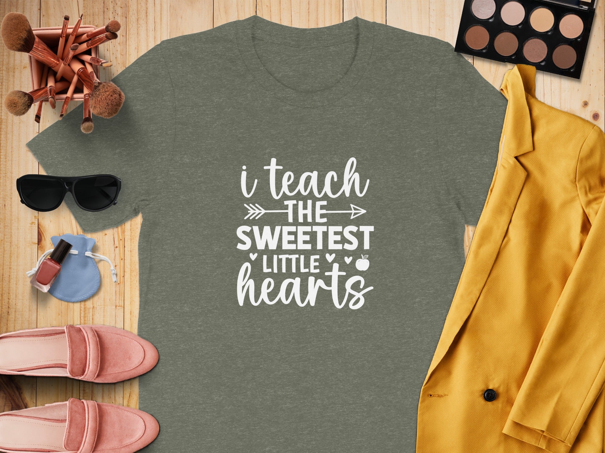 Olive green t-shirt with white text that says "i teach the sweetest little hearts."