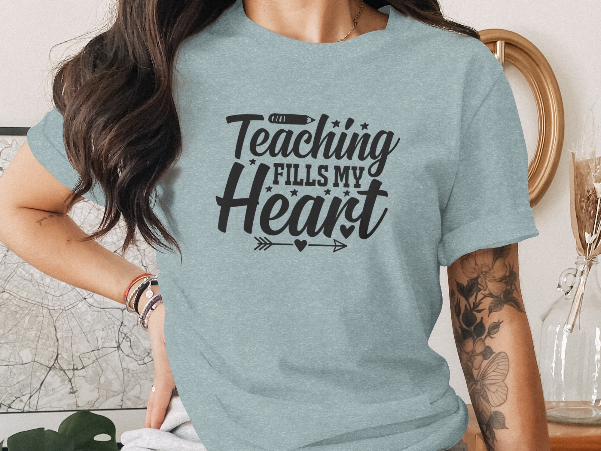 Light blue t-shirt with "Teaching Fills My Heart" text and pencil graphic.