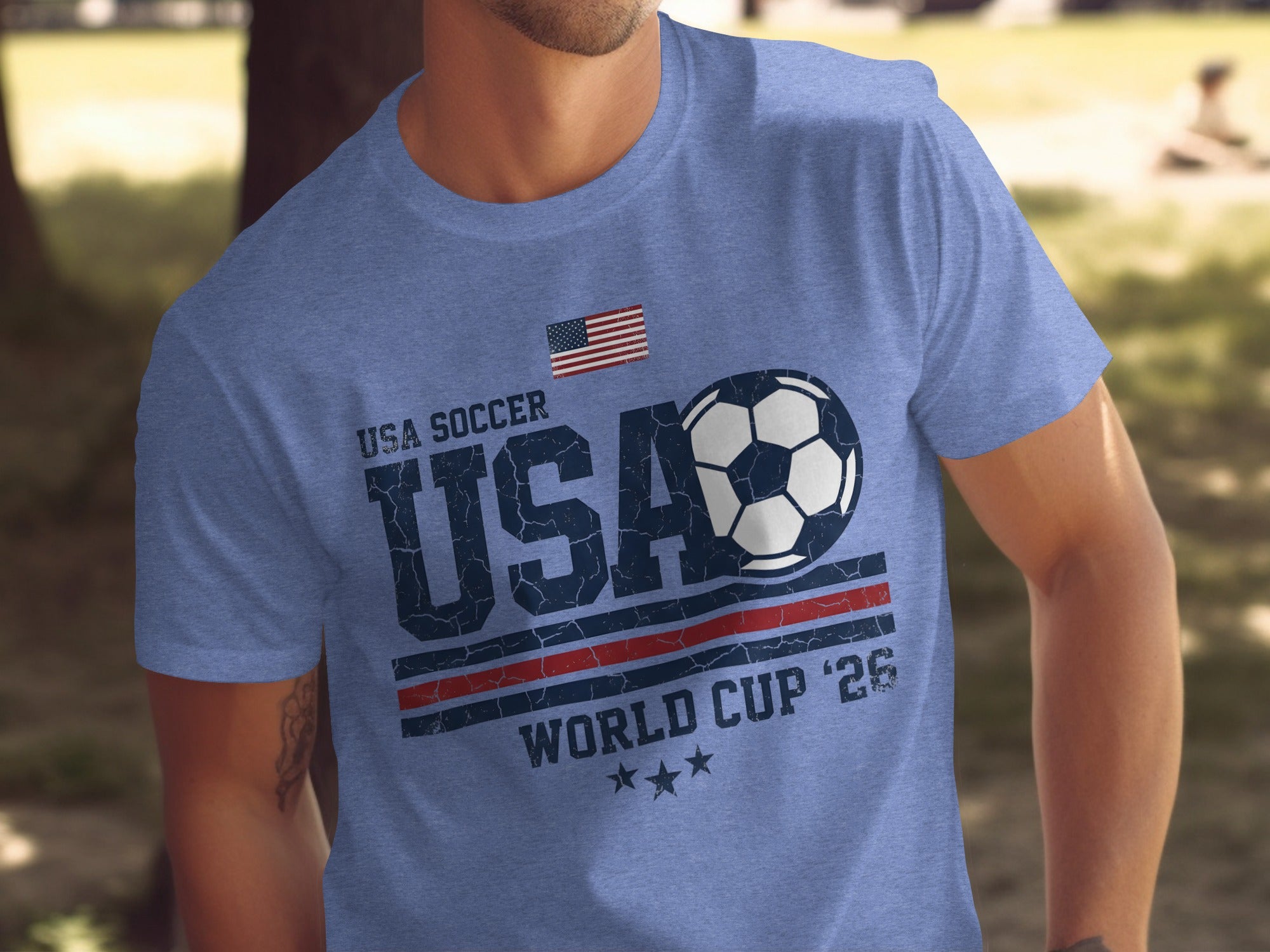 Blue t-shirt with USA soccer, soccer ball, and World Cup '26 graphic.