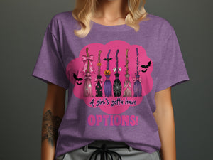 Purple t-shirt with a pink cloud graphic featuring Halloween brooms, bats, and text.