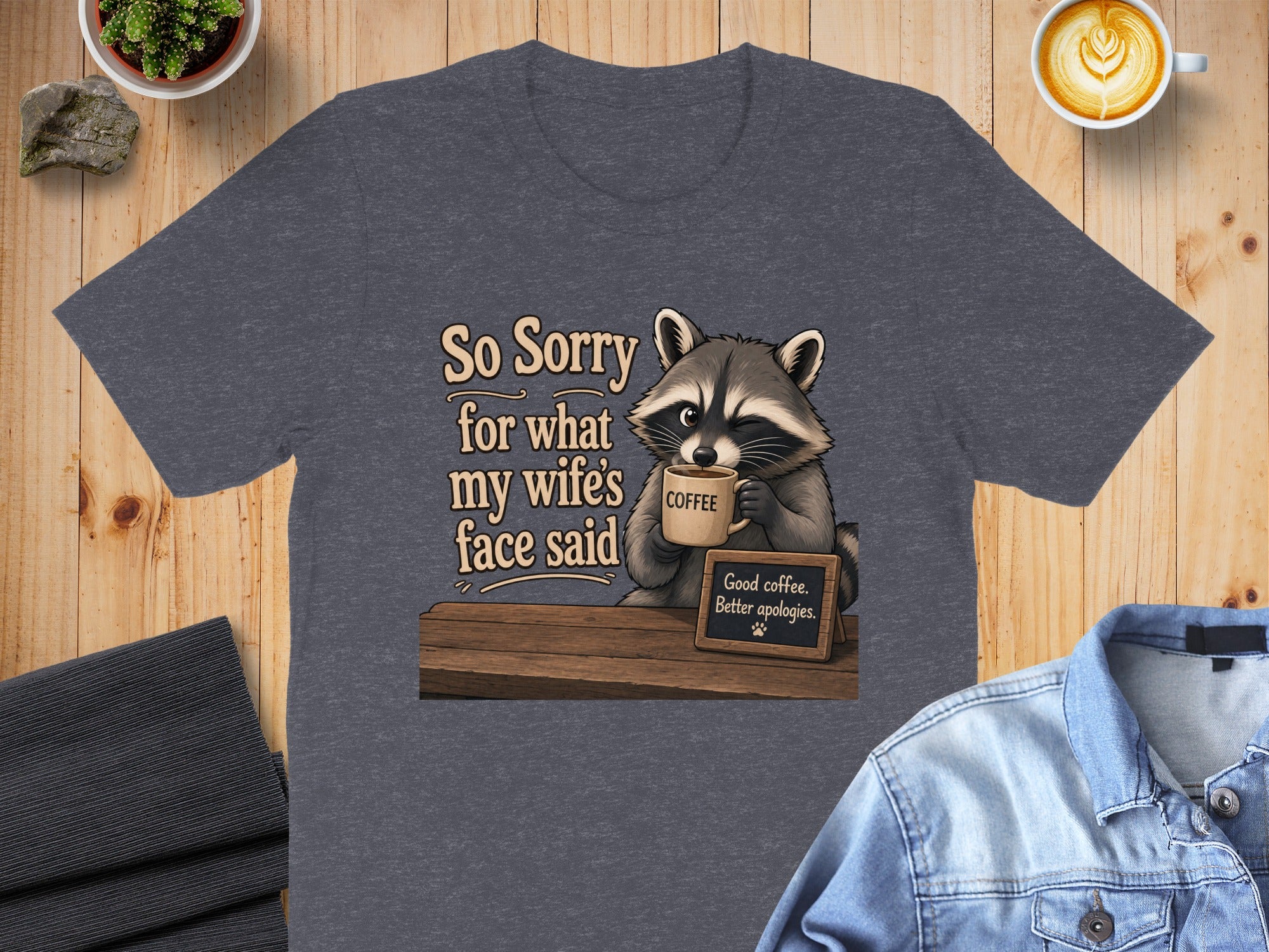 Raccoon drinking coffee with text "So Sorry for what my wife's face said" and "Good coffee. Better apologies."