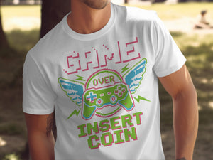 White t-shirt with pixelated "GAME OVER" and "INSERT COIN" text and a winged controller.
