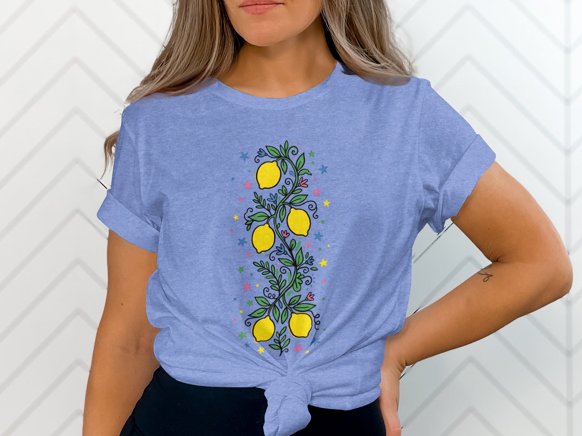 Light blue t-shirt with a vertical lemon branch and colorful stars design.