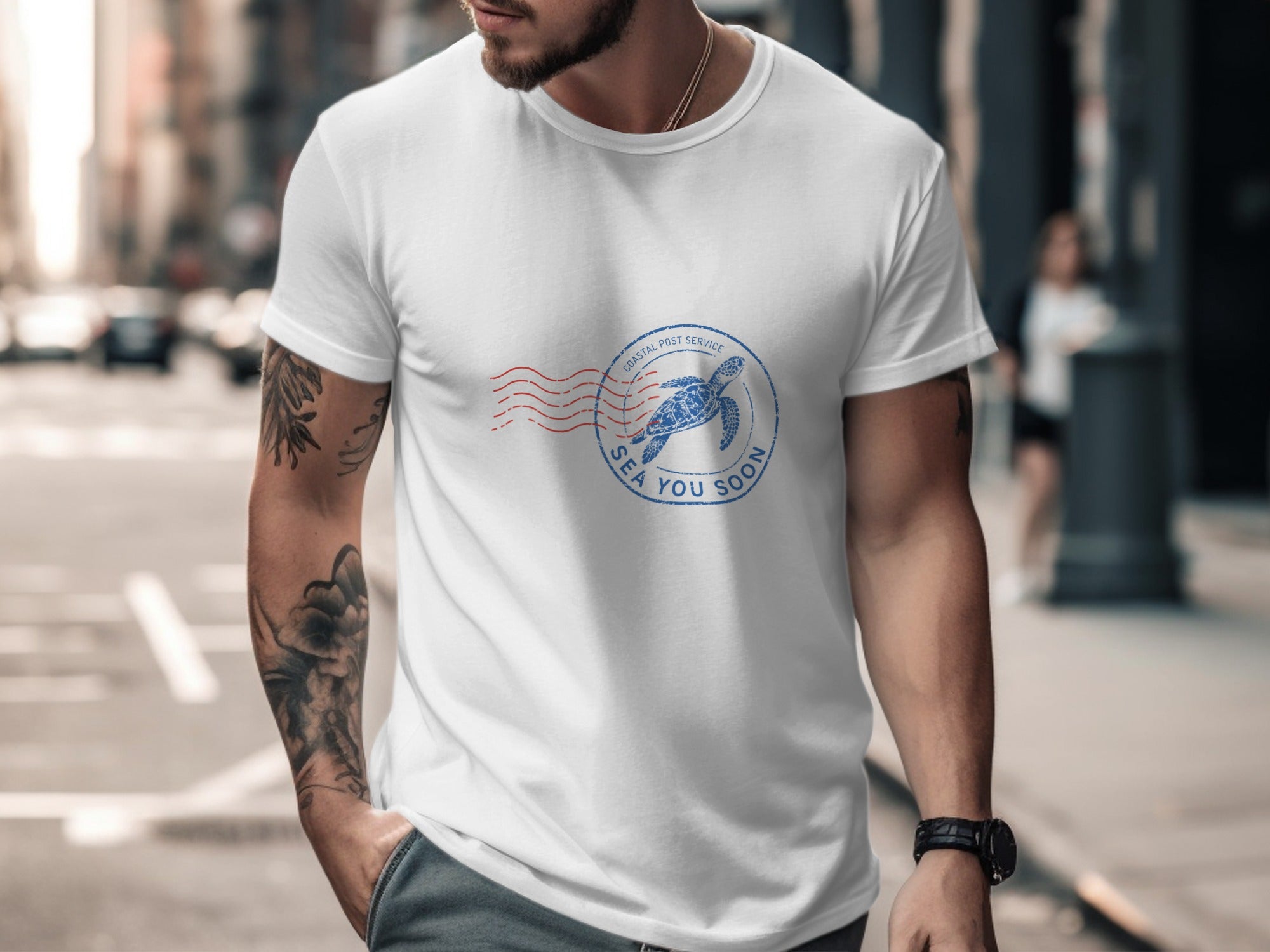 White t-shirt with circular blue stamp graphic featuring sea turtle and text.