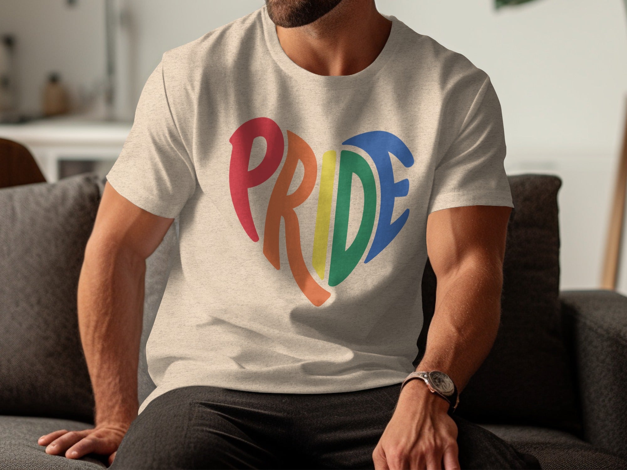 Cream t-shirt with rainbow heart Pride graphic on chest.