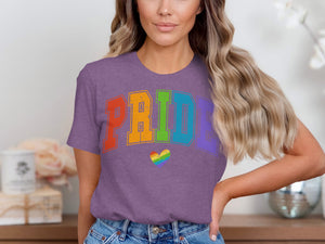 Purple t-shirt with "PRIDE" in rainbow varsity letters and a rainbow heart.