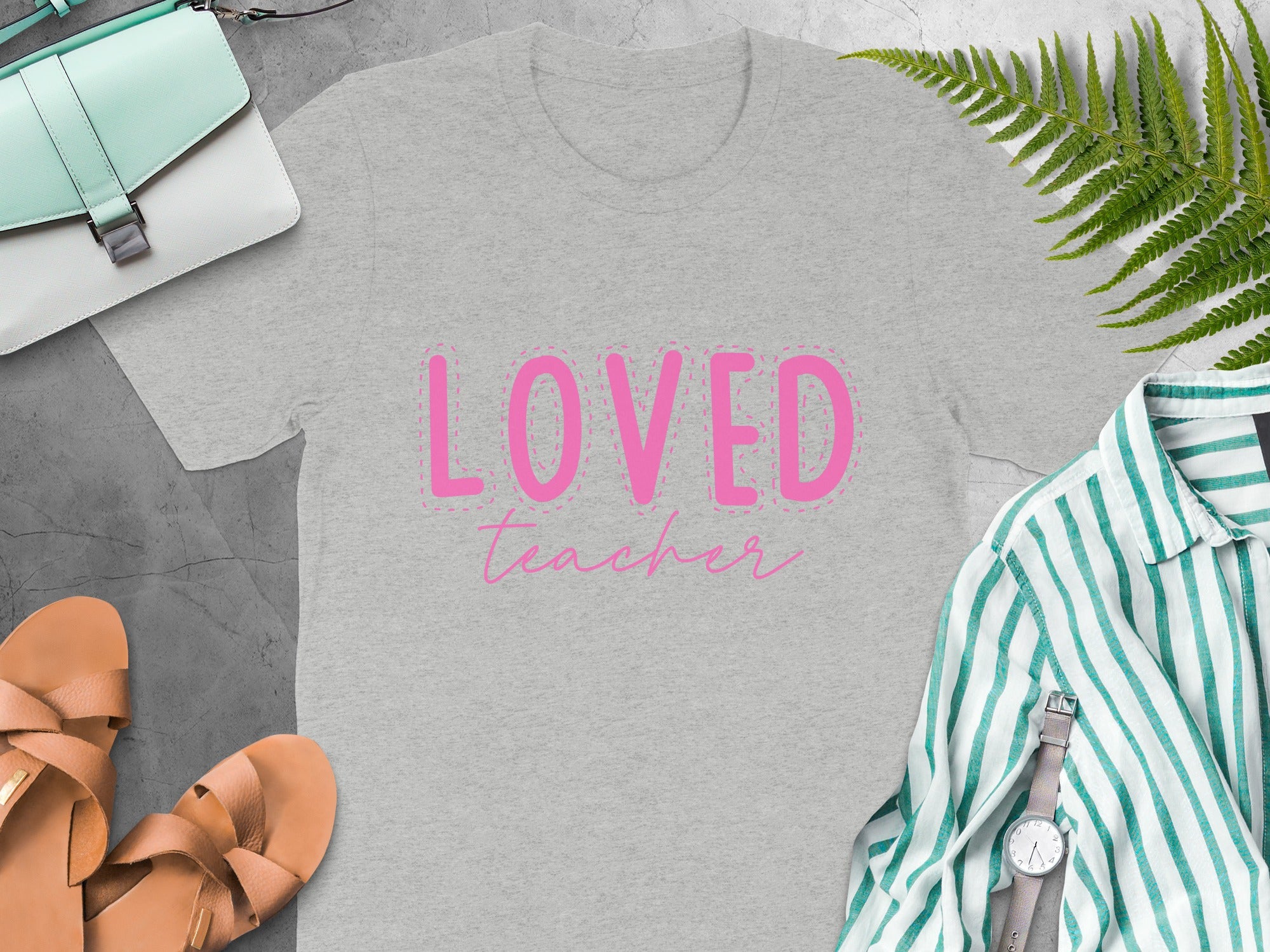 Gray t-shirt with pink "Loved Teacher" text and dashed border