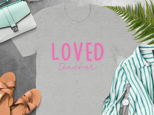 Gray t-shirt with pink "Loved Teacher" text and dashed border