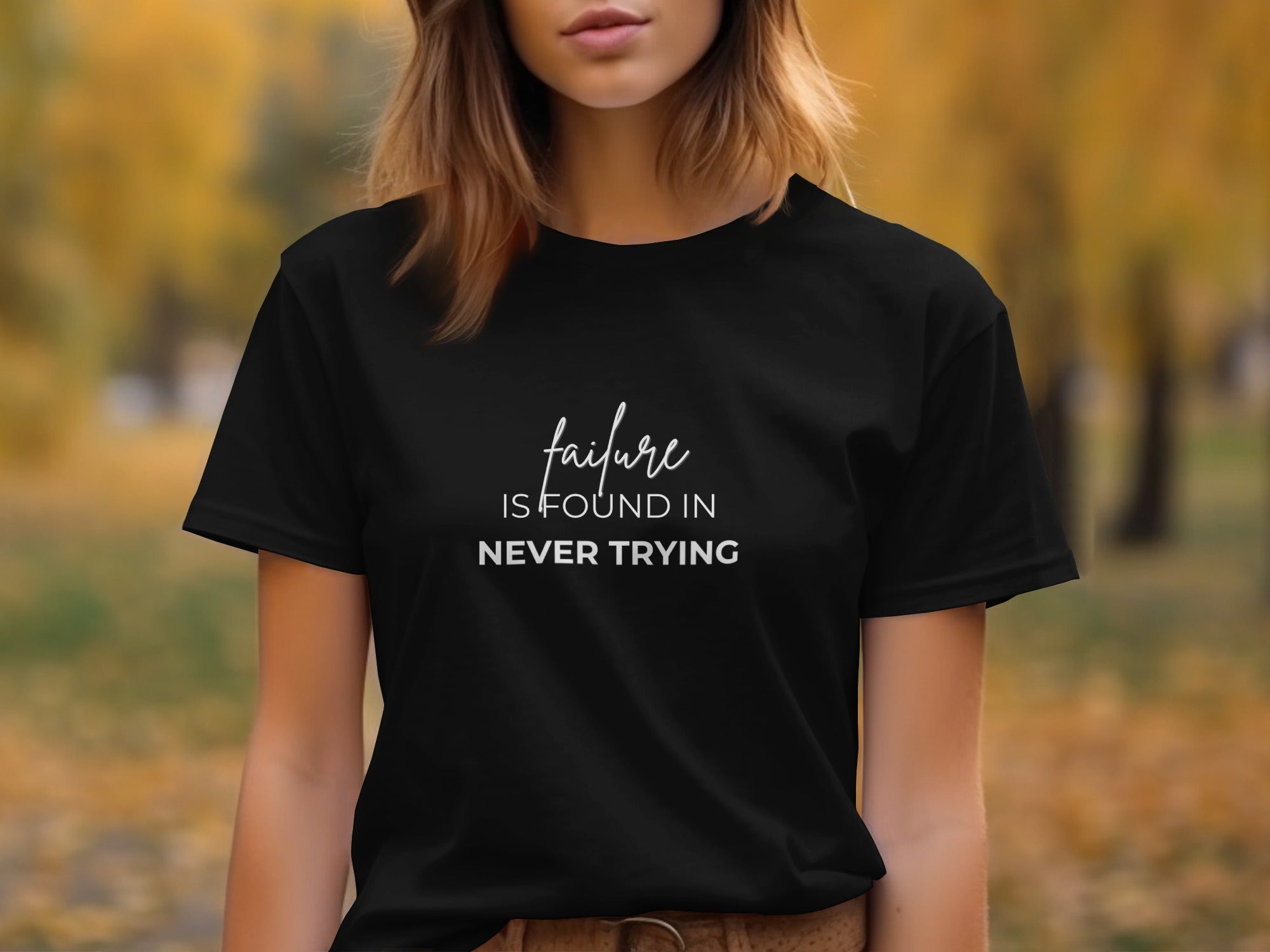 Black t-shirt with white text that reads "failure IS FOUND IN NEVER TRYING".