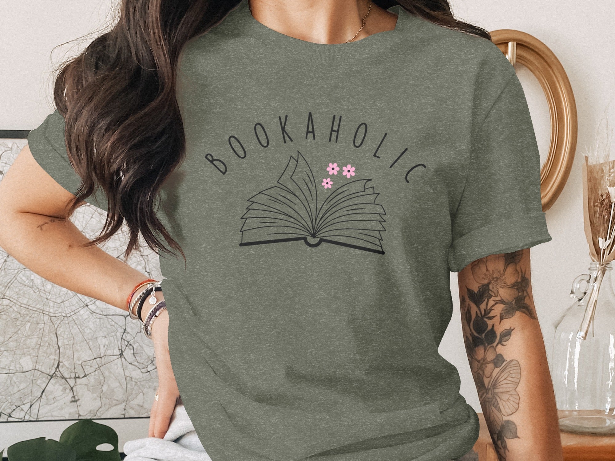 Green t-shirt with "BOOKAHOLIC" text and open book graphic with flowers.