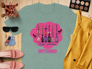 Teal t-shirt with Halloween-themed brooms and text "A girl's gotta have OPTIONS!".
