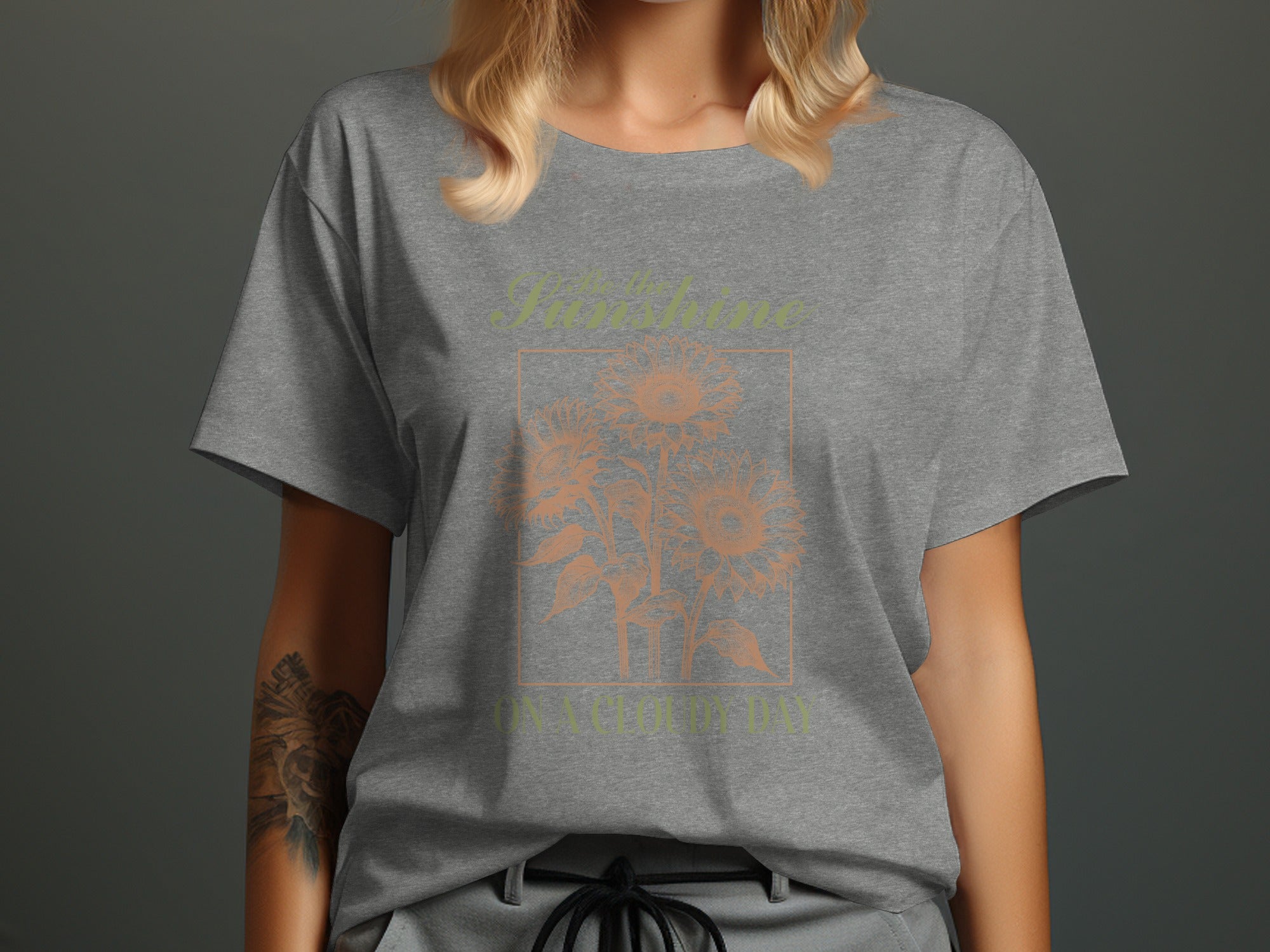 Grey t-shirt with sunflowers and text "Be the Sunshine on a Cloudy Day".