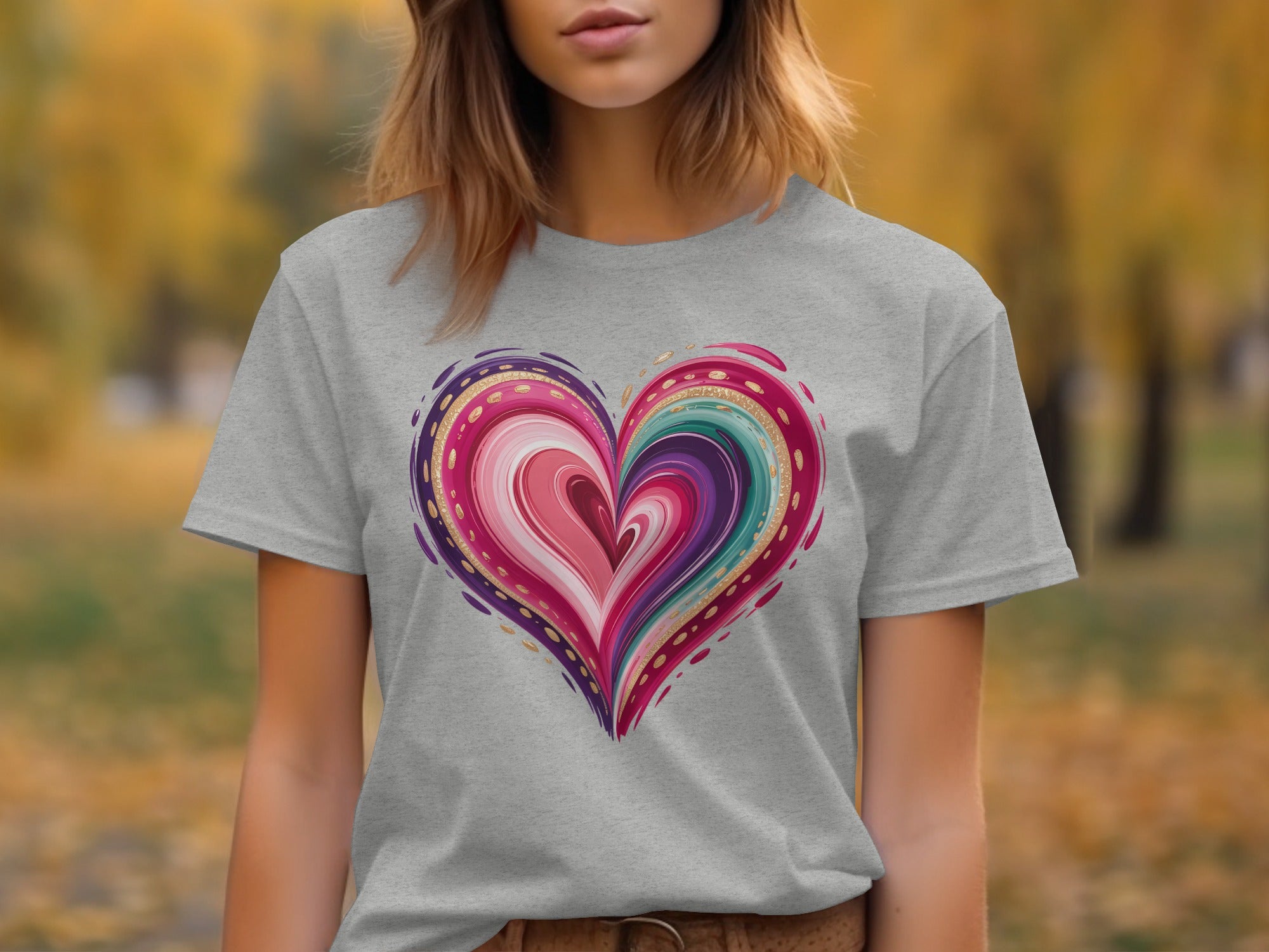 Grey t-shirt with a colorful, abstract heart graphic with gold accents.