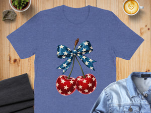 Blue t-shirt with graphic of cherries and a star-patterned bow.