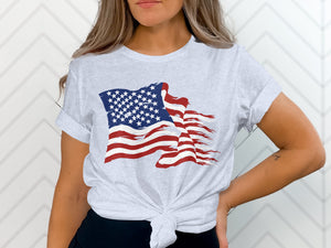 Light grey t-shirt with a distressed American flag graphic and a knotted hem.
