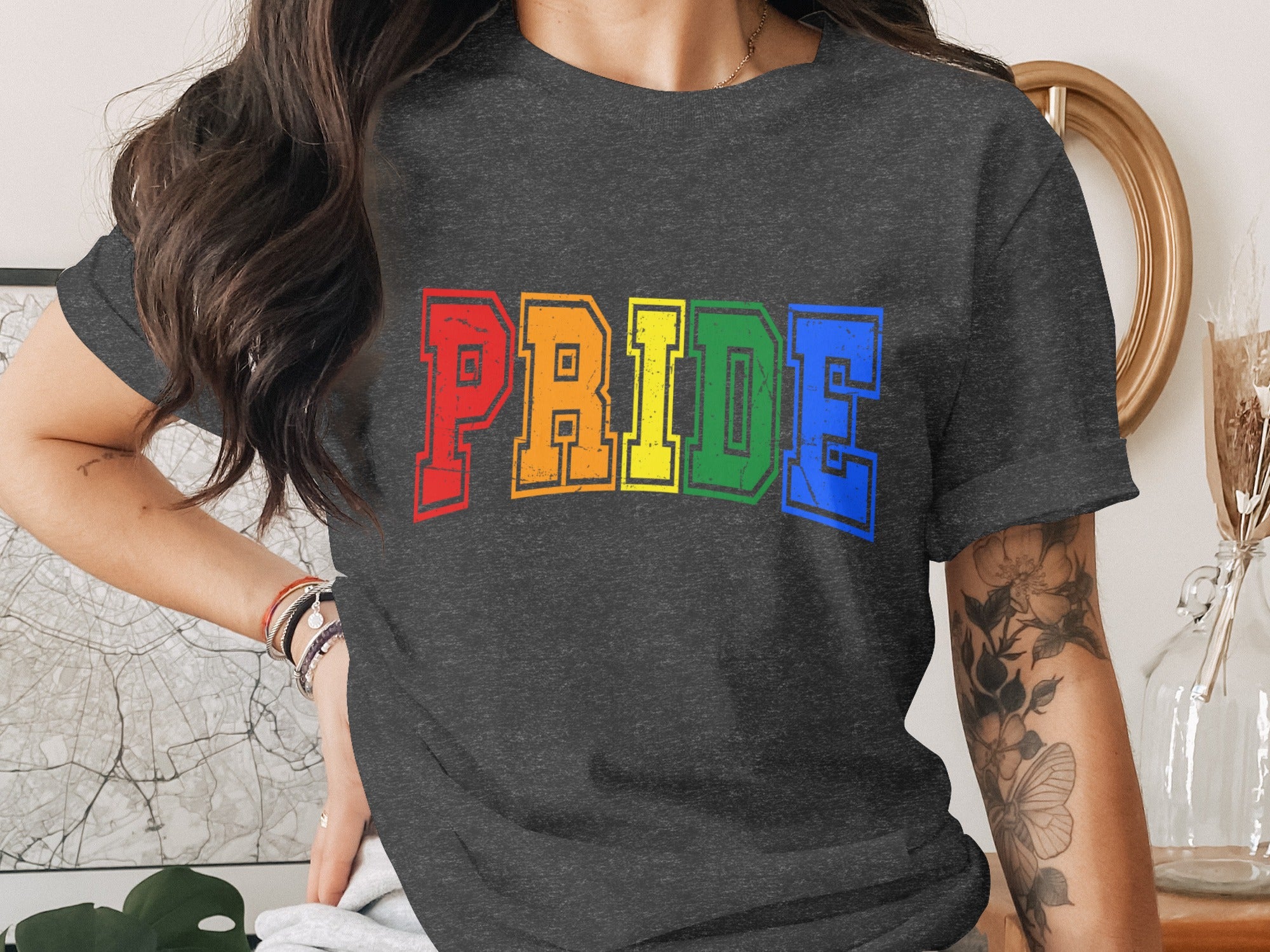 Dark grey t-shirt with colorful "PRIDE" text in rainbow colors.