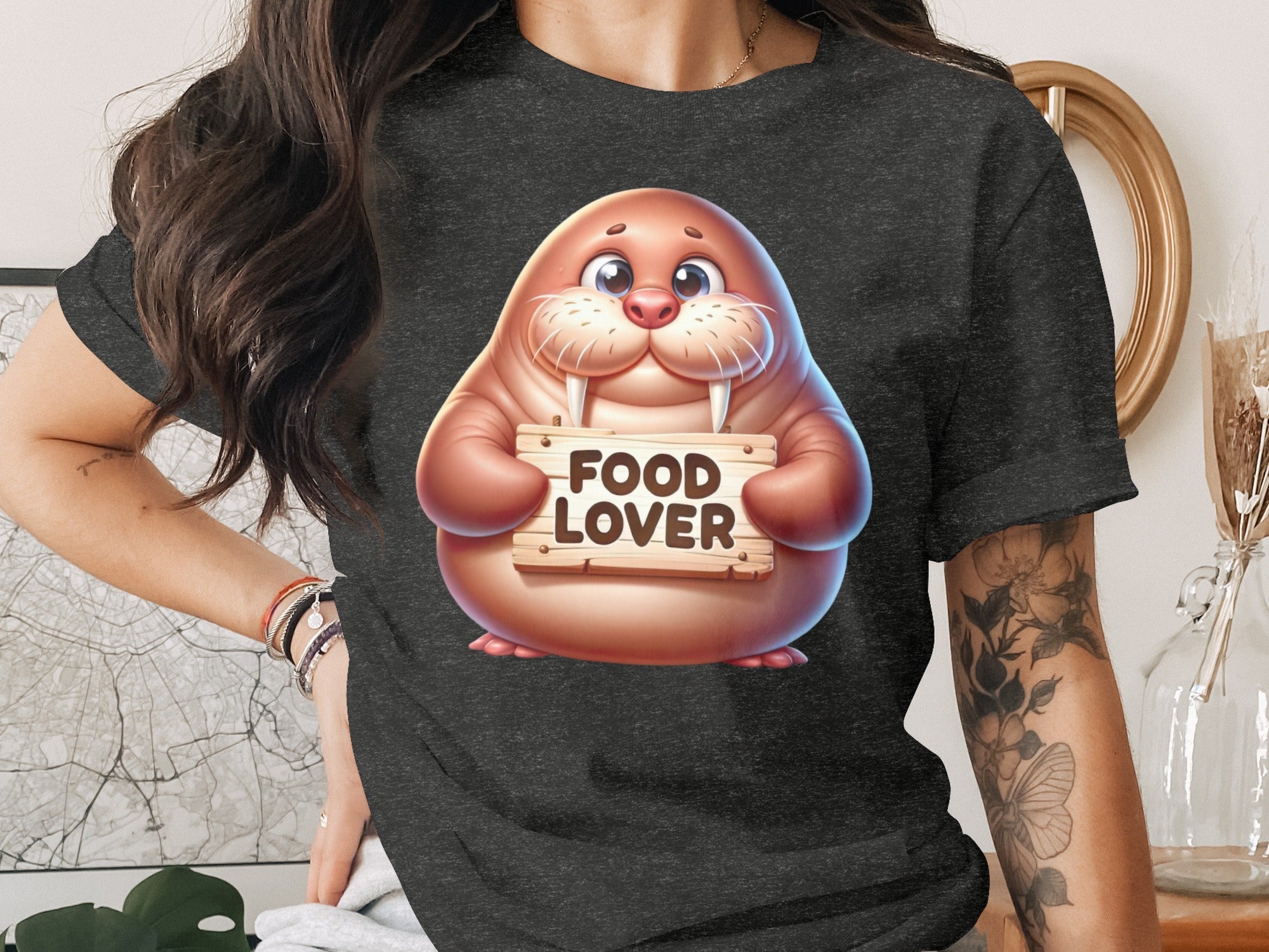 Walrus with large eyes holding a wooden sign with "FOOD LOVER" text.