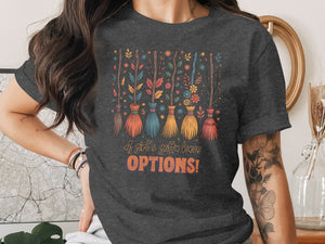Dark t-shirt with colorful brooms and flowers, reads "A girl's gotta have OPTIONS!"