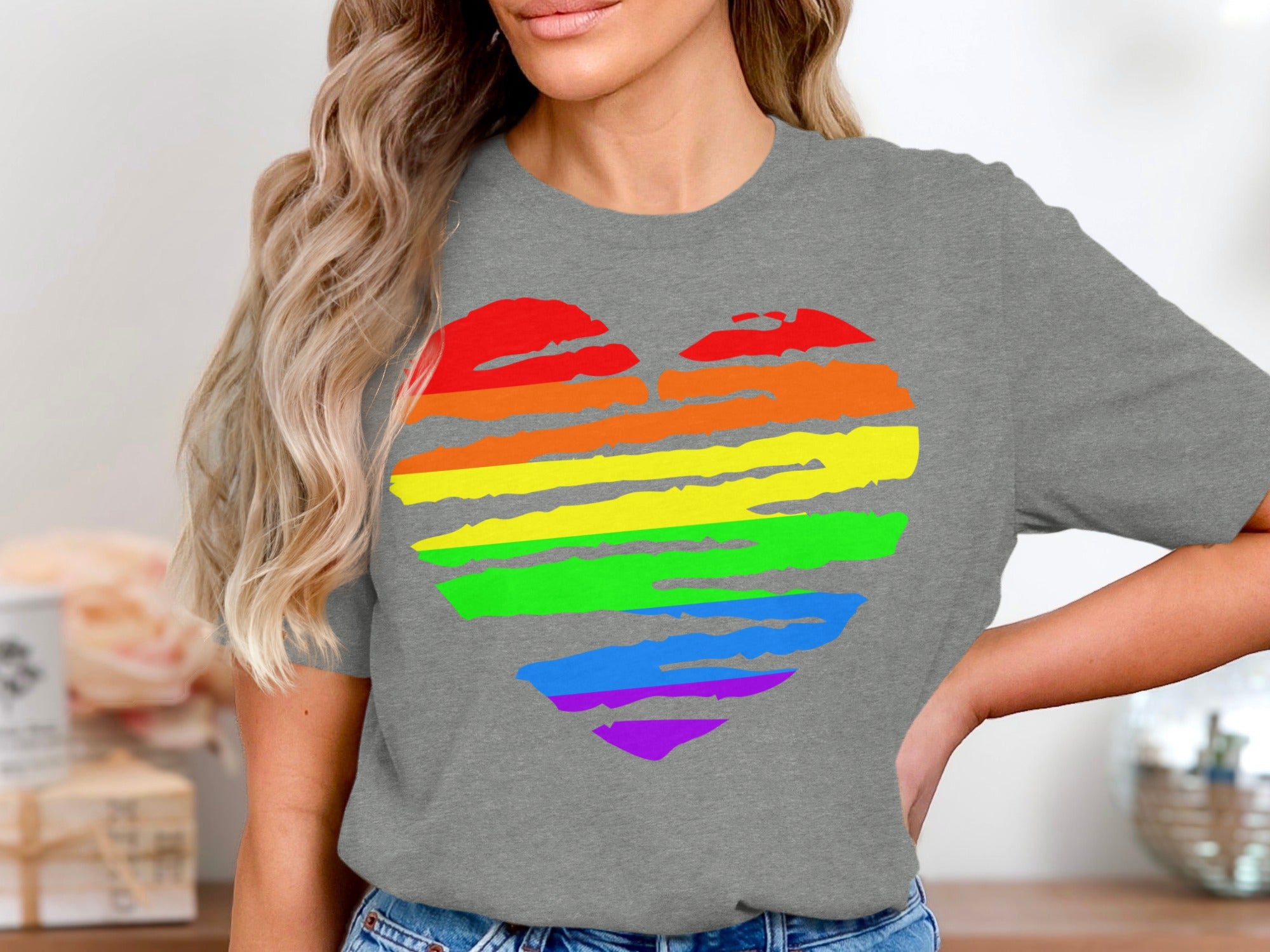 Grey t-shirt with a brushstroke rainbow heart design.