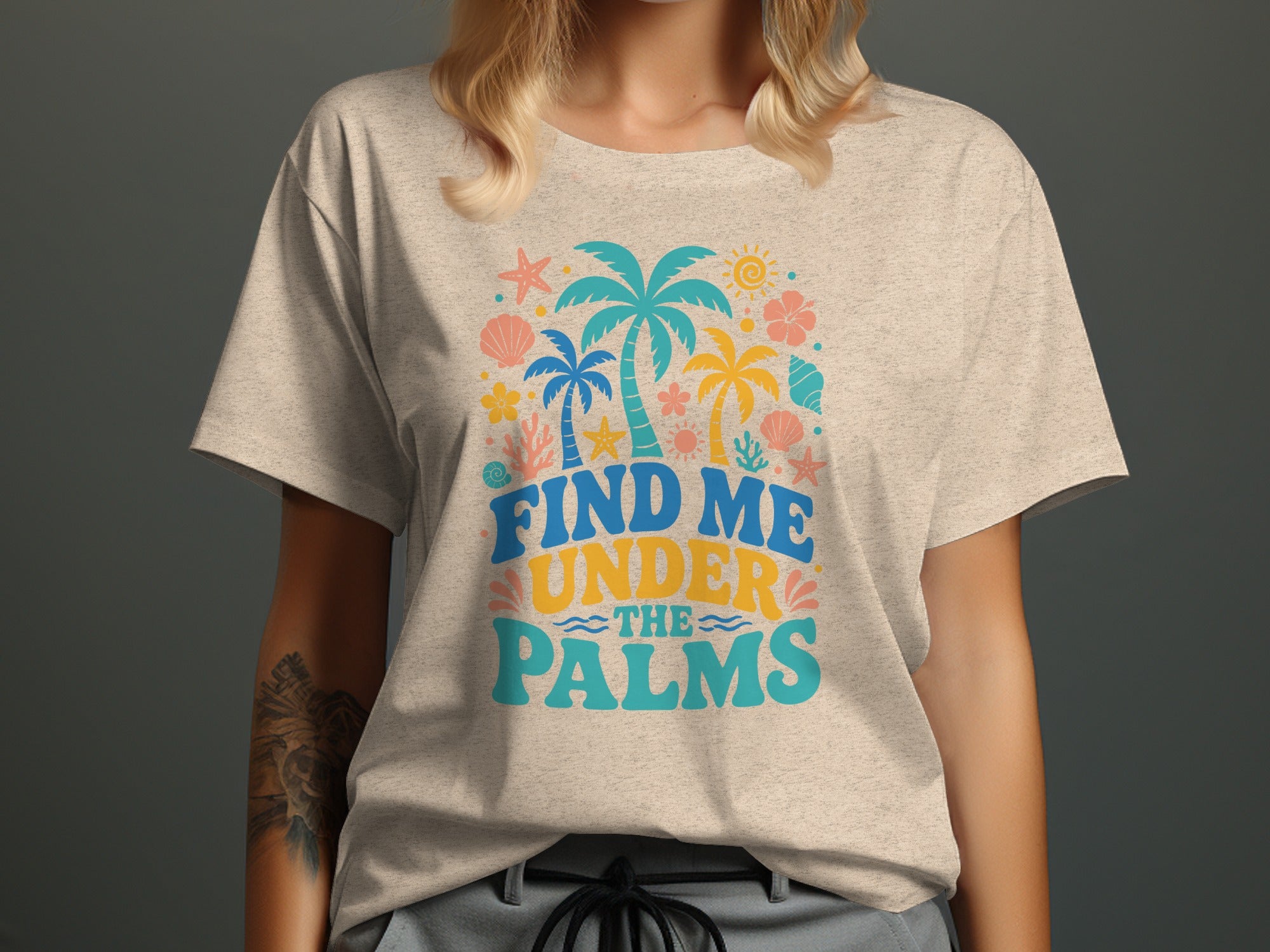 T-shirt with "Find Me Under The Palms" text and tropical graphics.