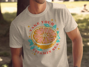 Light gray t-shirt with graphic of grapefruit slice and text "TAKE YOUR VITAMIN SEA."