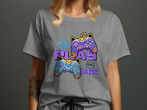 Gray t-shirt with cartoon cat controllers and text "New Level Play Cool Game".