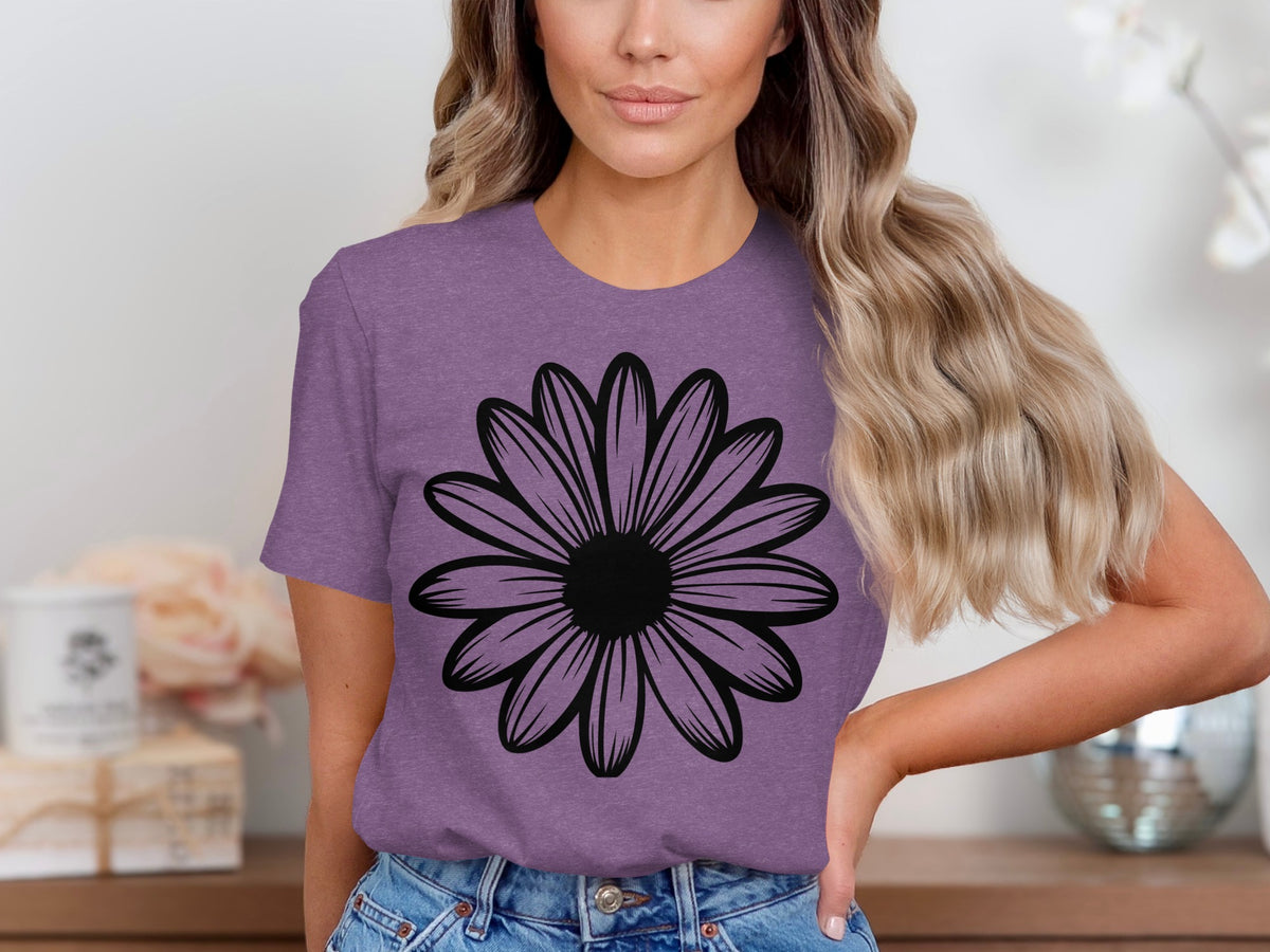 Woman wearing purple t-shirt with a black daisy graphic design.