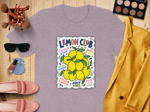 T-shirt with "Lemon Club" text and lemons, surrounded by summer vibes.