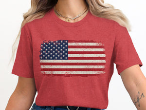 Distressed American flag graphic on a red t-shirt worn by a woman.