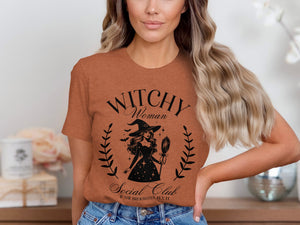 Orange t-shirt with "Witchy Woman Social Club" text and witch graphic.